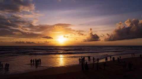 Timelapse - Sunset on the beach with people in foreground 4K60 Stock Footage 269122771