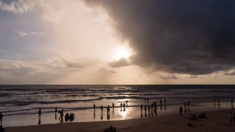 Timelapse - Sunset on the beach with people in foreground 4K60 Stock Footage 269122929