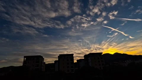 Timelapse of sunset behind buildings with planes Stock Footage 318751713