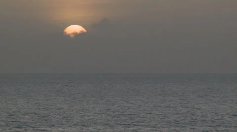 Timelapse sunset behind clouds on ocean Stock Footage 25510480
