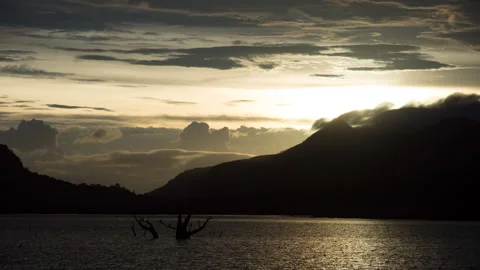 Timelapse - Sunset behind mountain with cloud on its peak 4K60 Stock Footage 269126498
