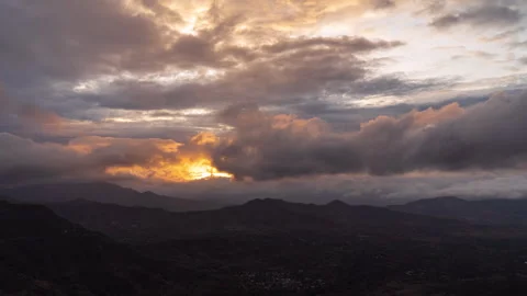 Timelapse - Sunset behind a mountain with clouds and colour explosion 4K60 Stock Footage 270084304