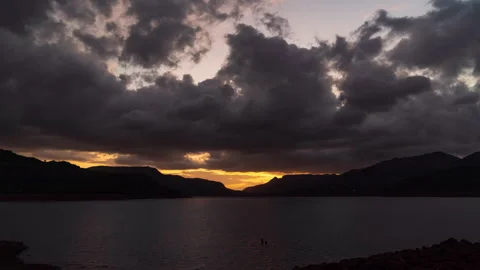 Timelapse - Sunset behind a mountain with dramatic clouds 4K60 Stock Footage 268790023