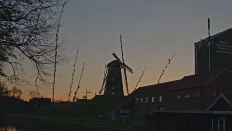 Timelapse at sunset of a classical windmill overlooking a beautiful 動画素材 234996285