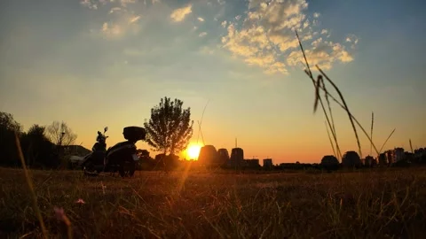 Timelapse of sunset on a clear sky with clouds passing while the sun sets behind Stock Footage 343835888