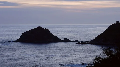Timelapse sunset with cloud over the sea with an island in background Stock Footage 89614885