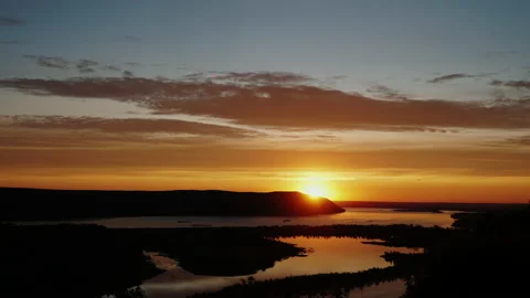 Timelapse of sunset with clouds and river when color changes from orange to red Video stock 166803351