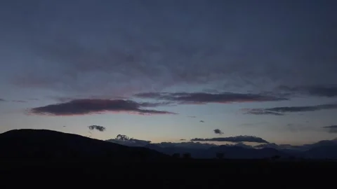 Timelapse sunset clouds drift above forested - Cloud Break and Cloud Transition Stock Footage 339561361
