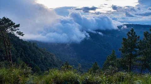 Timelapse at sunset. Clouds flow over mountains covered by rainforest. Stock Footage 115563849