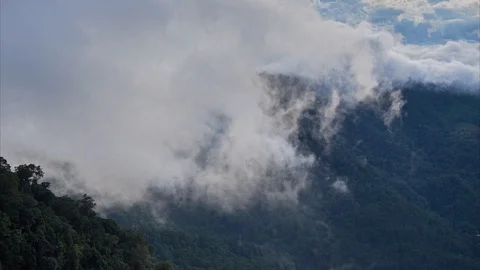Timelapse at sunset. Clouds flow over mountains covered by rainforest. Stock Footage 115581296