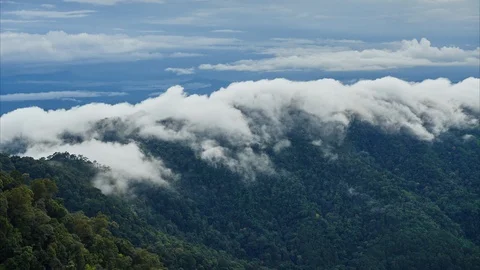 Timelapse at sunset. Clouds flow over mountains covered by rainforest. Stock Footage 120899065