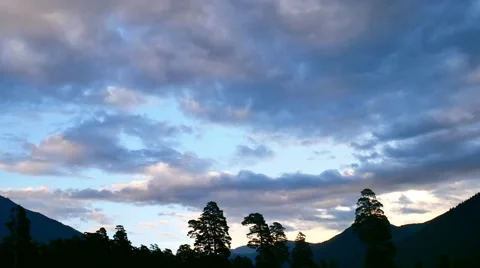 Timelapse of sunset with clouds in mountain forest, motionless silhouettes of 스톡 동영상 65567055