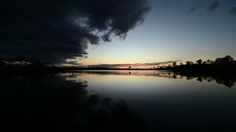 Timelapse of sunset clouds over Pine Glades Lake in Everglades National Park 4K. Stock Footage 220315295