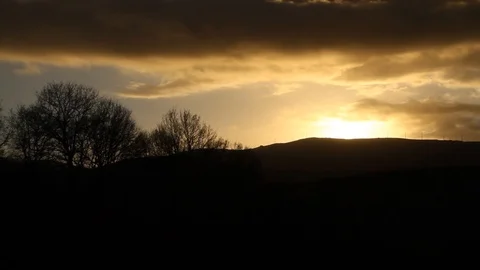Timelapse of a sunset with clouds over the sun Stock Footage 99118322
