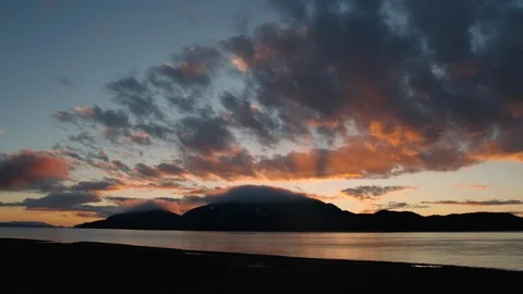 Timelapse of sunset clouds passing on sky with Cordova mountains in background Stock Footage 129114145
