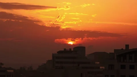 Timelapse sunset on the cloudy sky over city Stock Footage 100303647