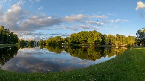 Timelapse of sunset evening clouds moving fast reflecting in river water surface 스톡 동영상 91434889