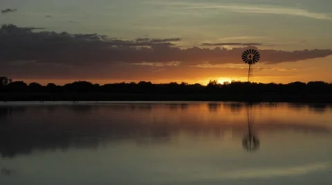 Timelapse sunset lake windmill dingo ducks australia Stock Footage 68709637