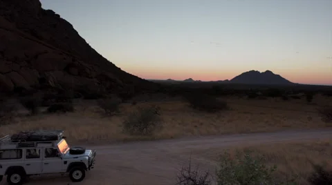 TIMELAPSE SUNSET WITH LANDROVER AND ROCK FORMATION HD Stock Footage 45341629