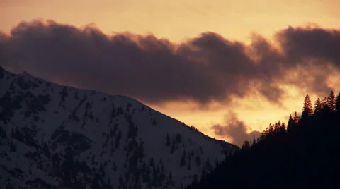 Timelapse sunset mountain peak and trees in winter Stock Footage 58649075