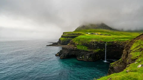 Timelapse of sunset at Mulafossur waterfall and Gasadalur village. Vagar, Faroe Video stock 163513962