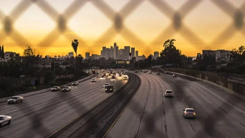 A Timelapse Sunset to Nightfall Over Downtown LA 405 freeway traffic Stock Footage 168340542