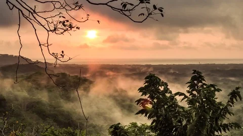 Timelapse of sunset, ocean, mist and fog coming out of tropical rainforest Stock Footage 70610643