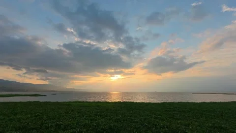 Timelapse of Sunset Over Calm Lake with Greenery 스톡 동영상 333609341