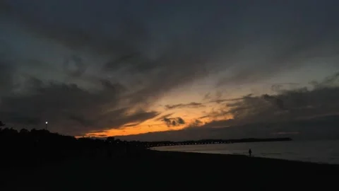 Timelapse of sunset over coast Stock Footage 138749785
