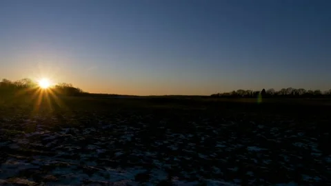 Timelapse of Sunset over field, Winter in Denmark Video stock 148976552