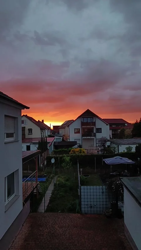 Timelapse. Sunset over the houses. Clouds are running fast across the sky. Stock Footage 240730285
