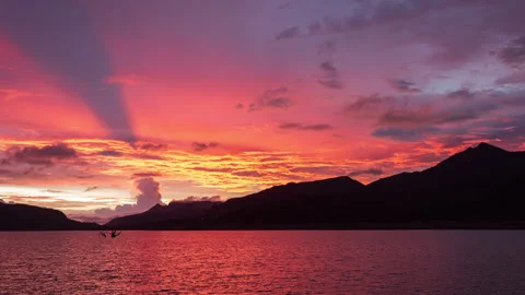 Timelapse - Sunset over lake behind mountains amazing colours 4K60 Stock Footage 269126766