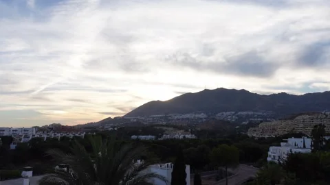 Timelapse of sunset over a mountain with residential buildings Stock Footage 285231815