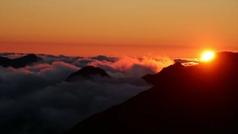 Timelapse of sunset over mountain tops with flowing clouds Stock Footage 126505396