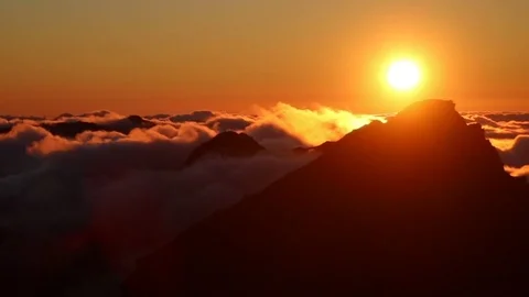 Timelapse of sunset over mountain tops with flowing clouds Stock Footage 126506469