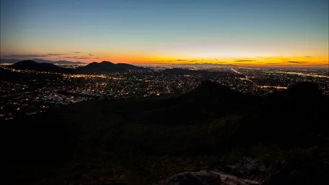 Timelapse of Sunset over Mountainous City Stock Footage 89554007