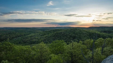 Timelapse of sunset over rolling hills of trees in Illinois	 Stock Footage