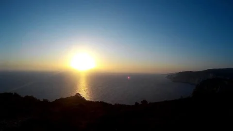 Timelapse Sunset Over the Sea and Rocky Shore Stock Footage 84151099