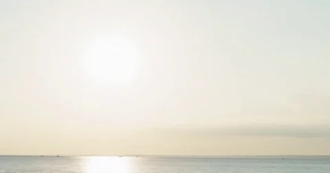 Timelapse of sunset over sea surface pan Stock Footage