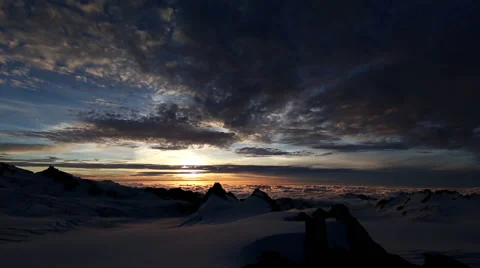 Timelapse of sunset over snowy mountain top Stock Footage