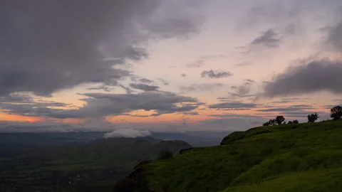 Timelapse - Sunset over a valley with clouds and colour explosion 4K60 Stock Footage 270083383