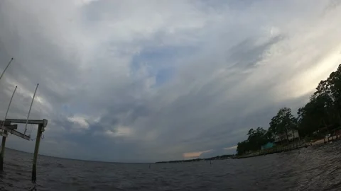 Timelapse of sunset over the water with clouds and storm front moving in. Stock Footage 161195324