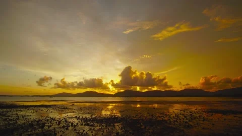 Timelapse sunset sea mountain cloud warping red orange sky background beautiful Stock Footage 153380766
