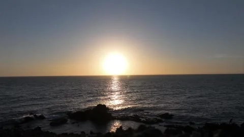 Timelapse of Sunset Shining on Ocean Breeze Rolling In Stock Footage 309950979