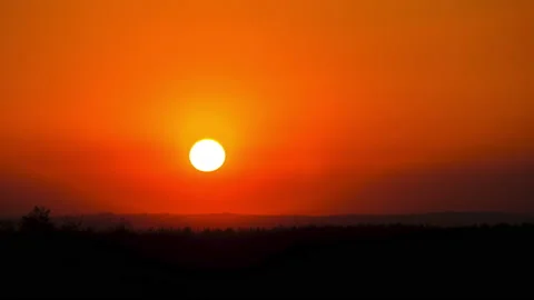 Timelapse Sunset in the Sky, Big Bright Yellow Sun Moves Down on the Horizon Stock Footage 167533594