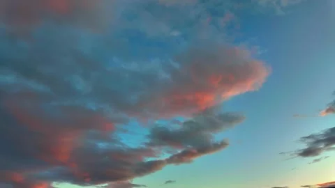 Timelapse of sunset sky with dramatic clouds painted in colorful shades Video stock 317386297