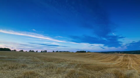 Timelapse of sunset sky over stubble field in countryside. Stock Footage 58715232
