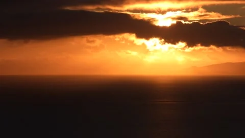Timelapse at sunset of the sun hiding between the clouds on the island of F.. Stock Footage 232624888