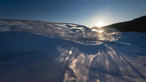 Timelapse of sunset trough transparent piece of icicle Stock Footage 174692632