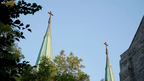 Timelapse of a sunset on two bell towers in Montreal with trees Stock Footage 81225564